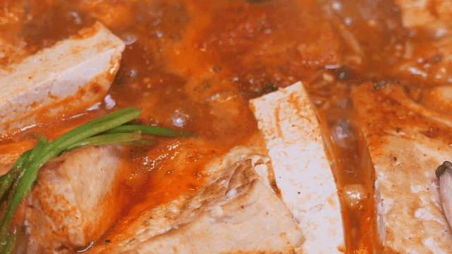 Kimchi stew boiling with tofu and vegetables