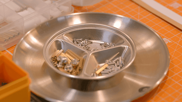 Various screws and bolts in a metal tray
