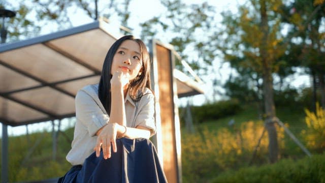 Woman sitting outdoors in the sunlight