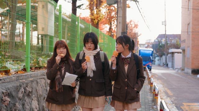 Students eating bungeoppang in winter