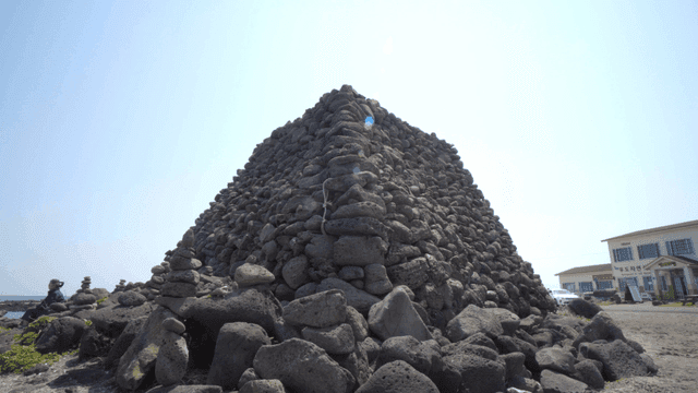 Stone tower by sea on clear day