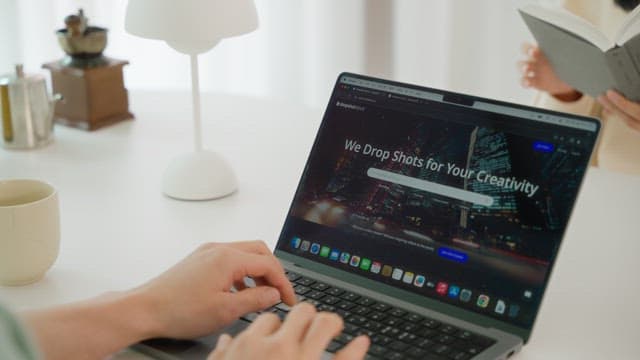 Man using laptop on the white table