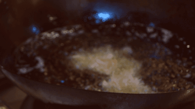 Chef frying shrimp in hot oil