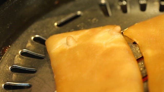 Pork rinds grilled over a grill