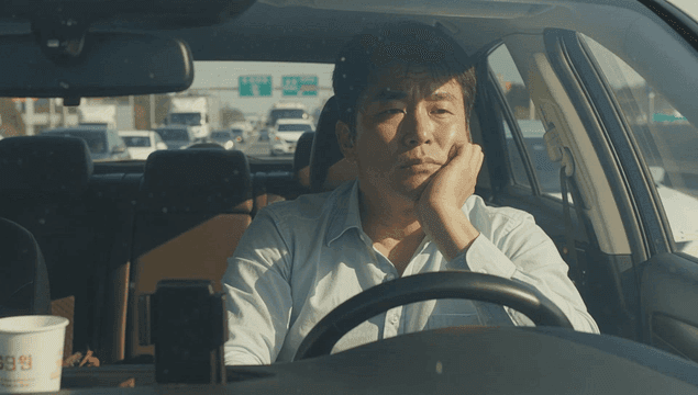 Man stuck in traffic looking pensive
