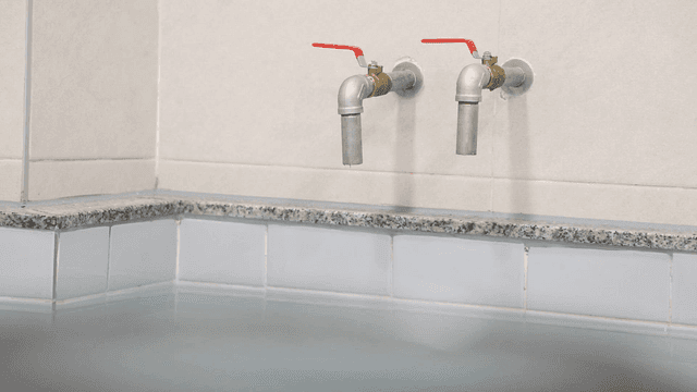 Water taps above a filled bathtub