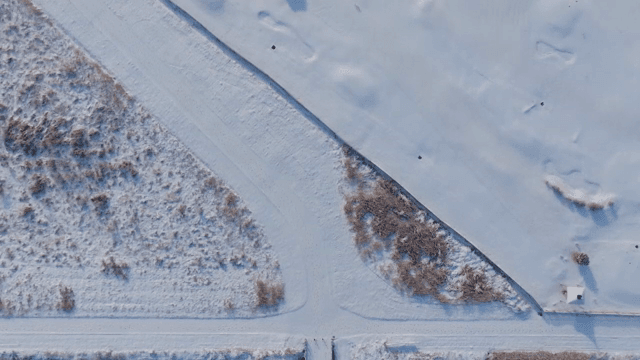 Snow-covered landscape with a bridge