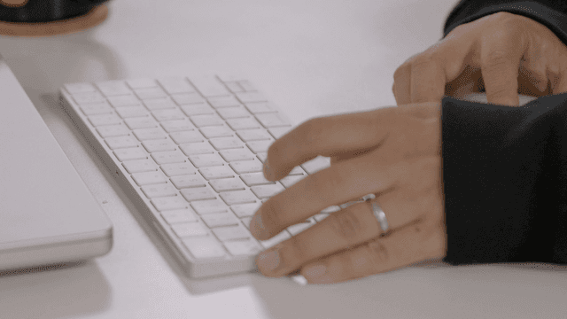 Hands typing on keyboard