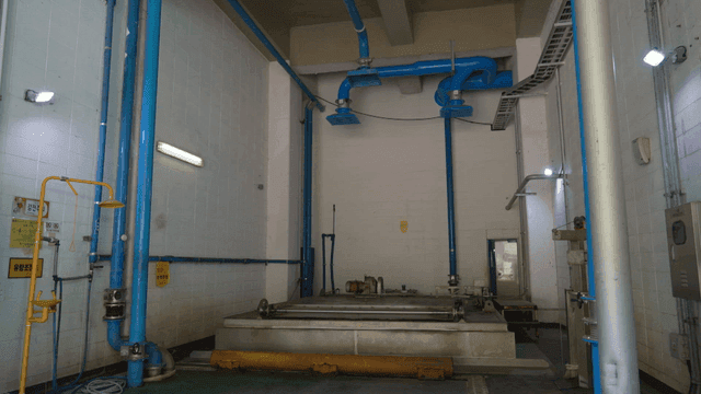 Industrial room with large blue pipes