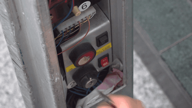 Person operating control panel with key