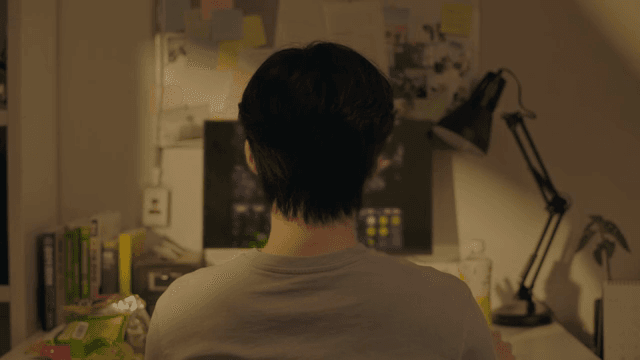 Person gaming at a desk in a cozy room