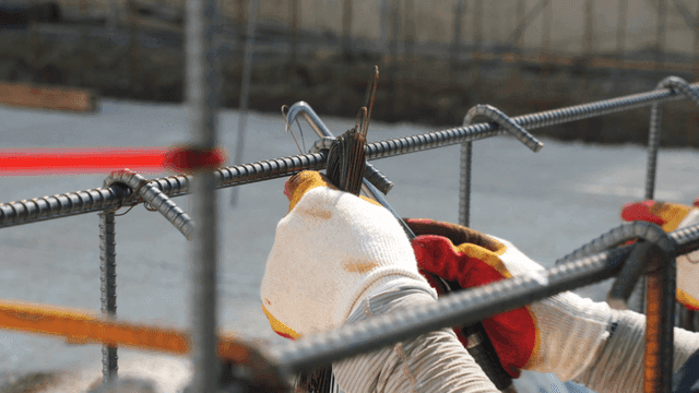 Worker tying rebar at a construction site