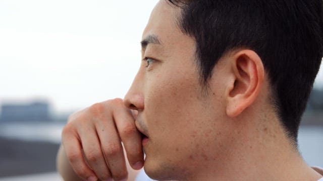 물가에서 생각에 잠긴 남자