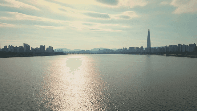 A river with a city skyline in the distance