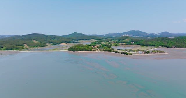 Coastal landscape with distant mountains