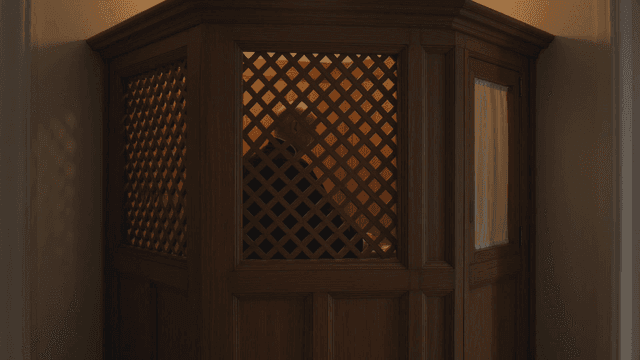 Priest sitting in church confession room
