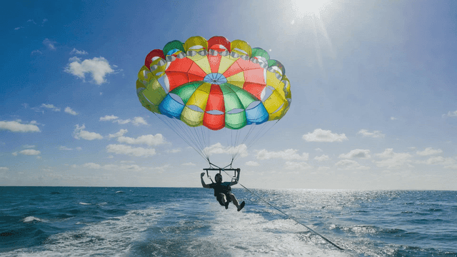 Parasailing over the ocean on a sunny day
