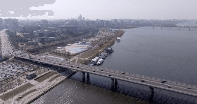 Bridge over a river with city skyline