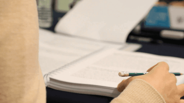 Person with pencil and book