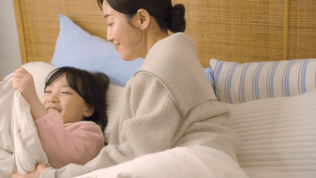 Mother and daughter sharing a happy moment in bed