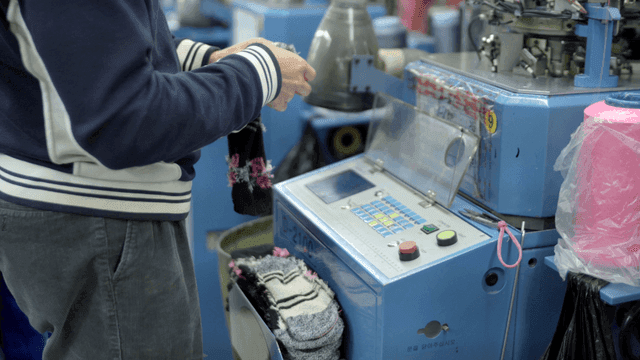 Person operating a knitting machine