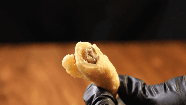 Hand holding fried anchovies