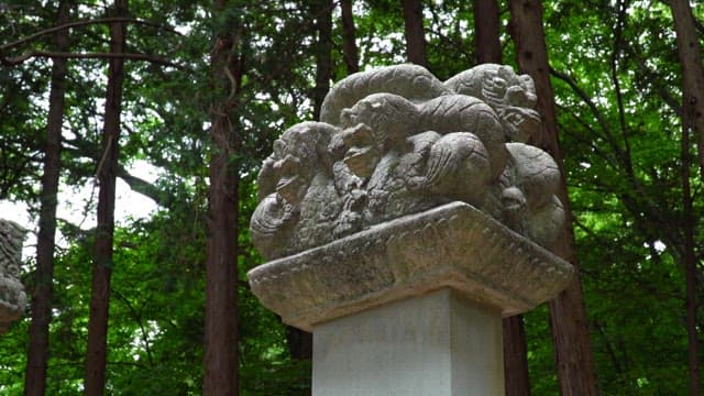 Intricate stone carvings decorating a monument in the forest