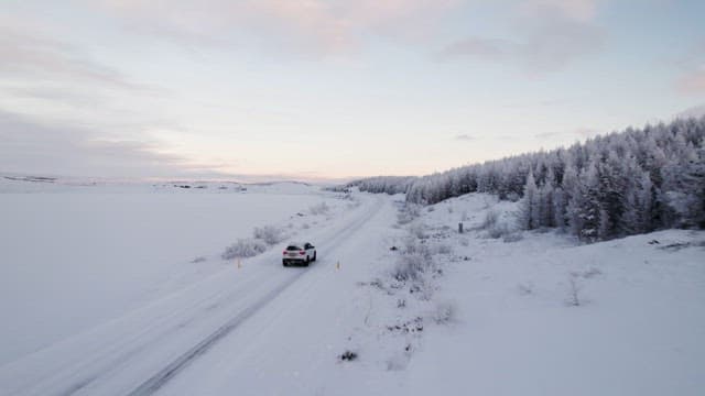 Car driving through a snowy landscape