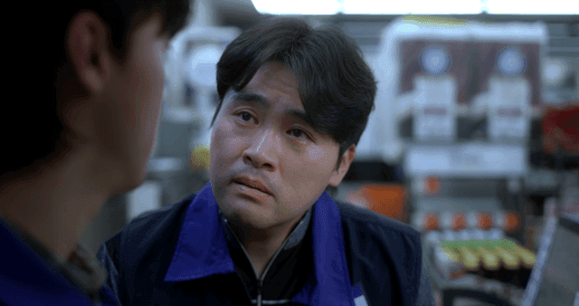 Middle-aged man staring at man in convenience store