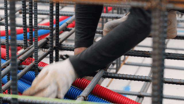 Worker assembling steel bars at a construction site