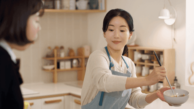 Mom serving soup in cozy kitchen