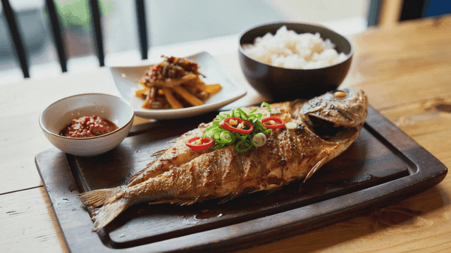 Grilled fish with rice and side dishes