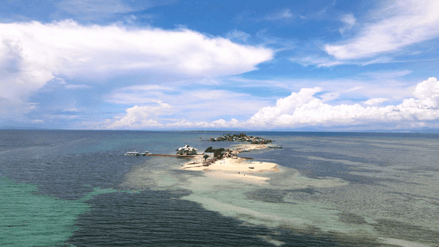 Small island surrounded by clear blue sea