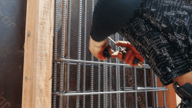 Worker tying rebar at a construction site