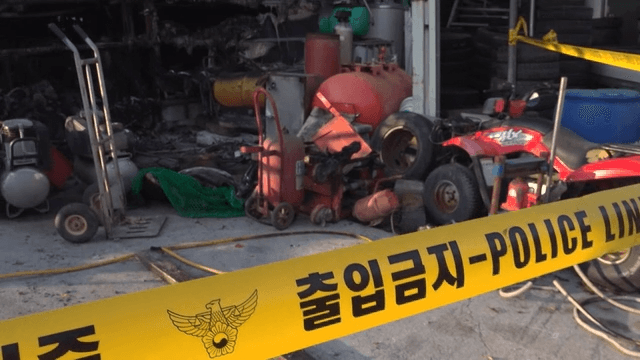Fire-damaged workshop with police tape