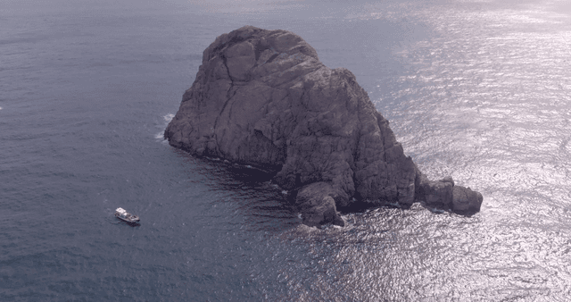 A rocky island surrounded by the sea