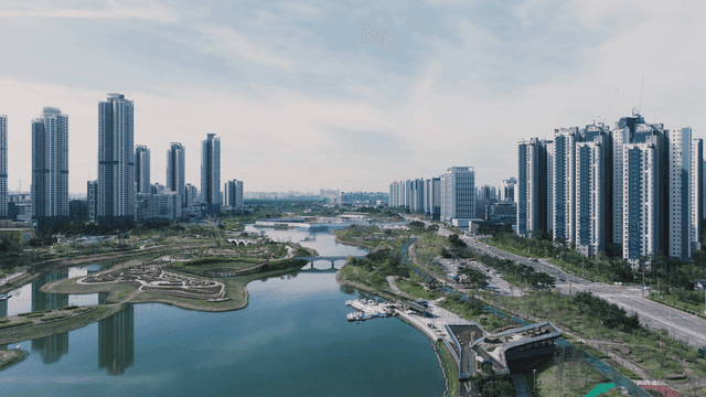 Modern cityscape with high-rise buildings and lake