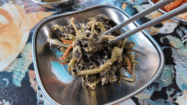 Chopsticks for seasoned dried radish greens on fancy table