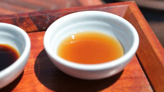 Three different types of soy sauce on wooden trays