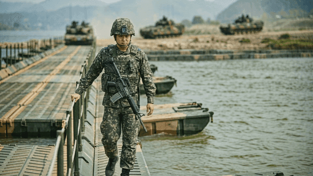 Soldier walking on pontoon bridge.
