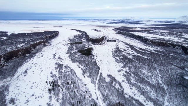 Snow-covered landscape with cliffs