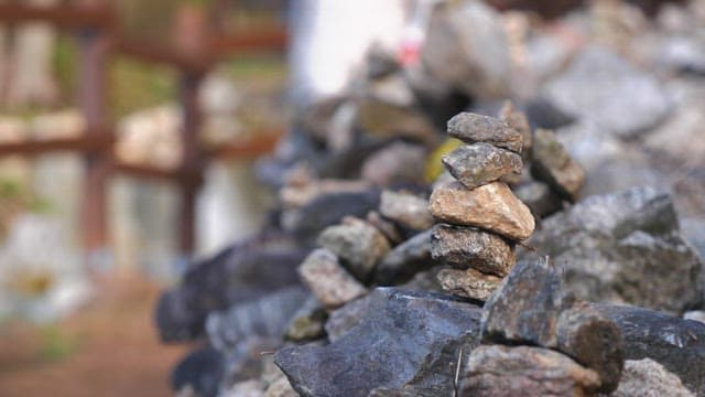 Small rock formation by a walking trail on a sunny day