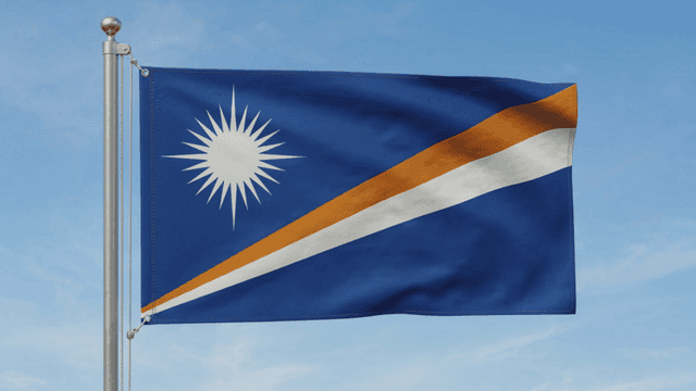 Flag of Republic of Marshall Islands fluttering against clear sky