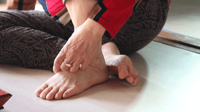 Elderly person sitting on the floor