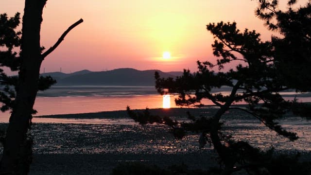 Serene Sunset Over Coastal Landscape