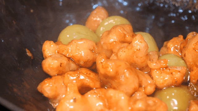 Grape chicken tangsuyuk being stir-fried in wok