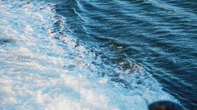 Waves Created by the Boat Way in the Open Blue Sea