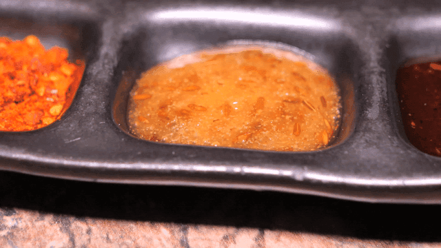 Various sauces in black bowl