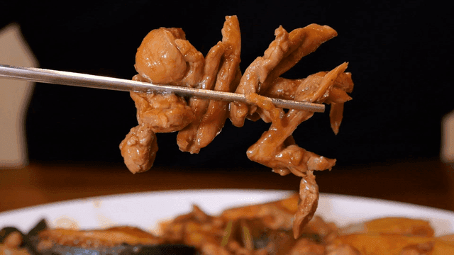 Chopsticks holding Korean braised chicken