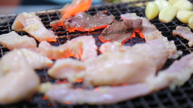 Sizzling Meat and Garlic on Grill